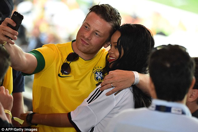 Rihanna celebrates Germanys World Cup win against Argentina By Flashing Her Bra